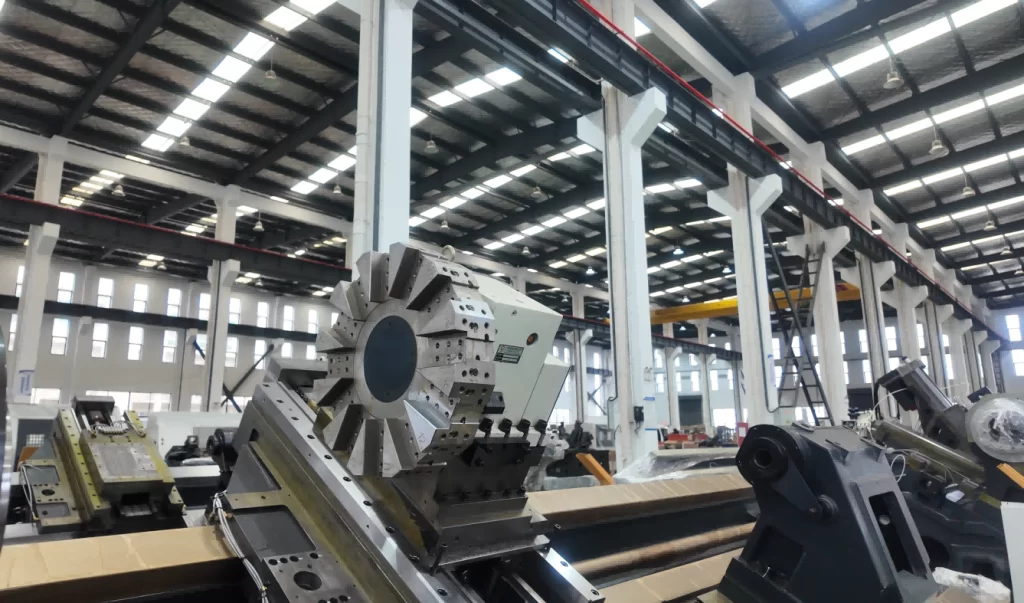 A slant bed CNC lathe standing on the assembly floor of a machine building hall before shipment