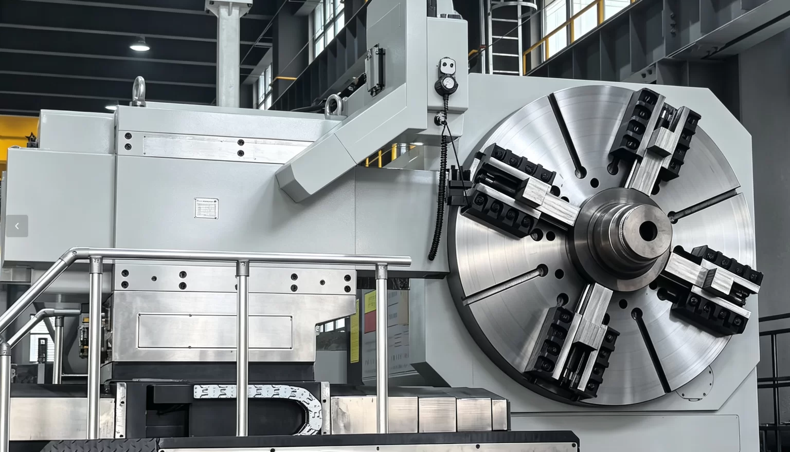 A large component being machined on a CNC lathe during the final machining stage before assembly